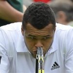 Jo-Wilfried Tsonga of France reacts as he sits in his seat after losing the second set in his men's singles tennis match against Ernests Gulbis of Latvia at the Wimbledon Tennis Championships, in London