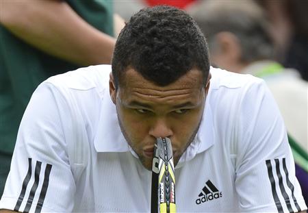 Jo-Wilfried Tsonga of France reacts as he sits in his seat after losing the second set in his men's singles tennis match against Ernests Gulbis of Latvia at the Wimbledon Tennis Championships, in London