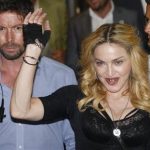 U.S. singer Madonna waves as she leaves the new Hard Candy Fitness centre in downtown Rome