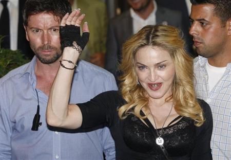 U.S. singer Madonna waves as she leaves the new Hard Candy Fitness centre in downtown Rome