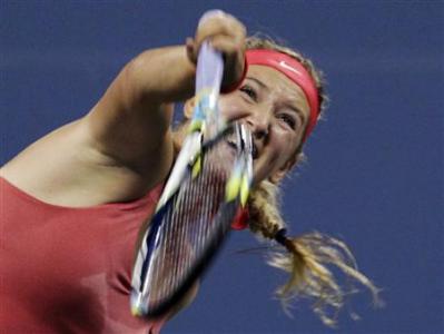 Azarenka of Belarus serves to Pfizenmaier of Germany during their first round match at the U.S. Open tennis championships in New York