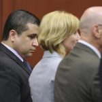 George Zimmerman looks down as his defense team react upon hearing the verdict in the 2012 shooting death of Trayvon Martin at the Seminole County Criminal Justice Center in Sanford Florida