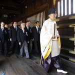 A group of lawmakers are led by a Shinto priest as they visit the Yasukuni Shrine in Tokyo