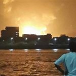 A man watches Indian Navy submarine INS Sindhurakshak on fire in Mumbai