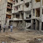 Activists look for dead bodies to collect samples to check for chemical weapon use, in the Zamalka area in the eastern suburbs of Damascus