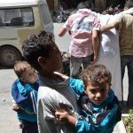 Children who survived what activists say is a gas attack is seen along a street in Damascus