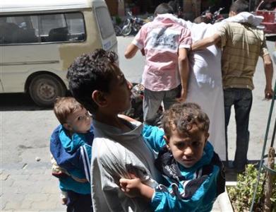 Children who survived what activists say is a gas attack is seen along a street in Damascus