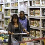 A shopper pushes a trolley of groceries at the Makro branch of South African retailer Massmart in Johannesburg