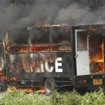 A police truck burns