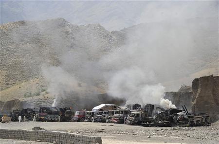 Smoke rises from burning NATO supply trucks after a Taliban attack at Torkham district