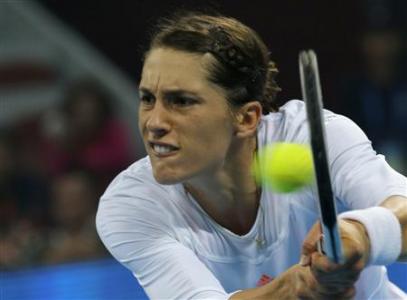 Petkovic of Germany hits return against Azarenka of Belarus at the China Open tennis tournament in Beijing
