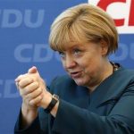 Hesse's Prime Minister Bouffier Geman Chancellor Merkel gestures before CDU party board meeting in Berlin