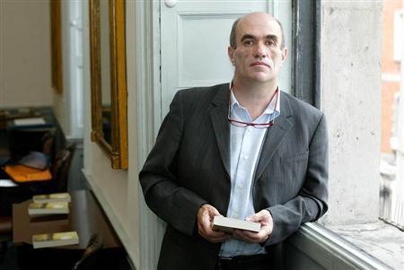 Irish author Colm Toibin poses for photographers after he won the world's richest literary prize for..