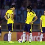 Colombia's players restart the game after conceding a goal to Uruguay's during their 2014 World Cup qualifying soccer match in Montevideo