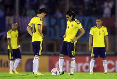 Colombia's players restart the game after conceding a goal to Uruguay's during their 2014 World Cup qualifying soccer match in Montevideo