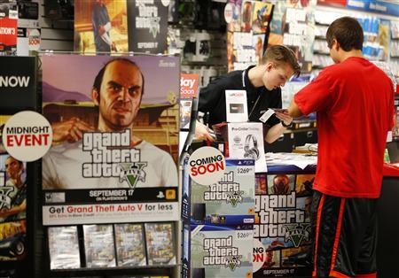 Game enthusiasts purchase the latest release of "Grand Theft Auto Five" after the game went on sale at the Game Stop store in Encinitas, California