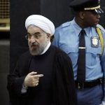 Iran's President Hassan Rouhani talks to a United Nations official as he departs after concluding his address to the 68th United Nations General Assembly at U.N. headquarters in New York