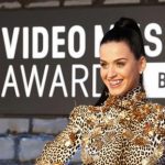 Singer Katy Perry shows off her bejeweled teeth on arrival for the 2013 MTV Video Music Awards in New York