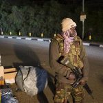 Police officers guard the edge of a security perimeter put into place a distance from the Westgate Shopping Centre in Nairobi, during a standoff operation between security forces and gunmen