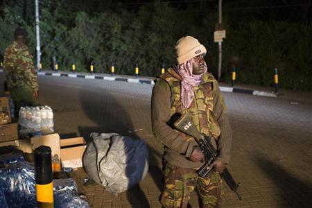 Police officers guard the edge of a security perimeter put into place a distance from the Westgate Shopping Centre in Nairobi, during a standoff operation between security forces and gunmen