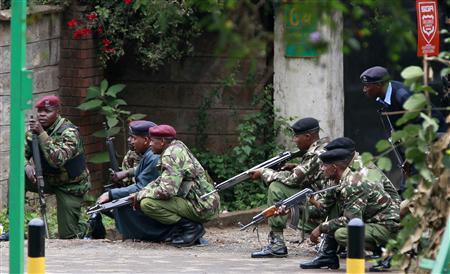 Police officers take position during the ongoing military operation at the Westgate Shopping Centre in Nairobi