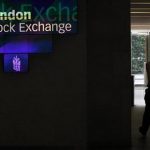 A man walks through the lobby of the London Stock Exchange