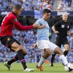 Manchester City's Sergio Aguero, centre, keeps the ball