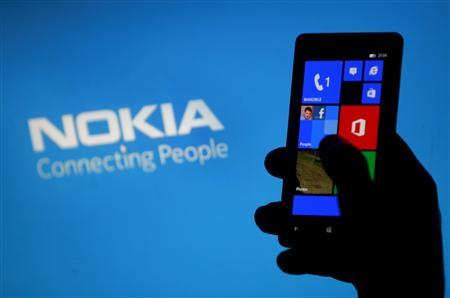 File illustration photo shows a woman posing with a Nokia Lumia smartphone in the central Bosnian town of Zenica