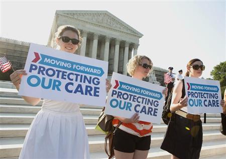 Supporters of the Affordable Healthcare Act gather in front of the Supreme Court before the court's announcement of the legality of the law
