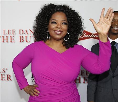 Actress Oprah Winfrey, a cast member of the film "Lee Daniels' The Butler", poses at the film's premiere in Los Angeles