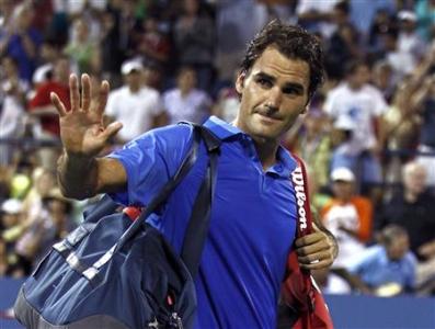 Federer of Switzerland waves as he walks off the court after losing in three sets to Robredo of Spain at the U.S. Open tennis championships in New York