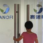 Employee walks into an office of French drugmaker Sanofi in Shanghai