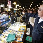 South Korea's Prime Minister Jung Hong-won holds up a domestic fish during his visit to the Noryangjin fisheries wholesale market in Seoul