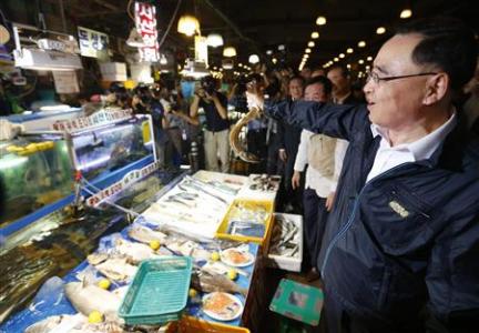 South Korea's Prime Minister Jung Hong-won holds up a domestic fish during his visit to the Noryangjin fisheries wholesale market in Seoul