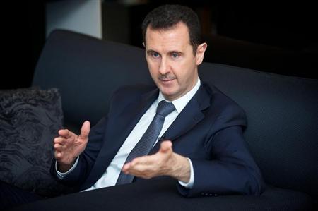 Syria's president Bashar al-Assad gestures during an interview with French daily Le Figaro in Damascus