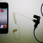 Illustration picture of application icons of Facebook Twitter and Google on iPhone next to earphone set in Berlin