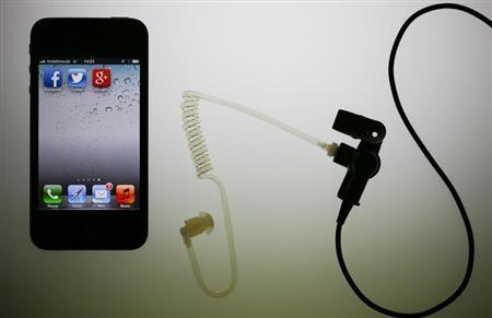 Illustration picture of application icons of Facebook Twitter and Google on iPhone next to earphone set in Berlin