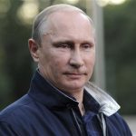 Russia's President Putin looks on during a meeting with journalists in Vladivostok