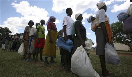 Zimbabwean villagers collect their monthly rations of food aid from Rutaura Primary School in Rushinga district of Mt Darwin about 254km north of Harare