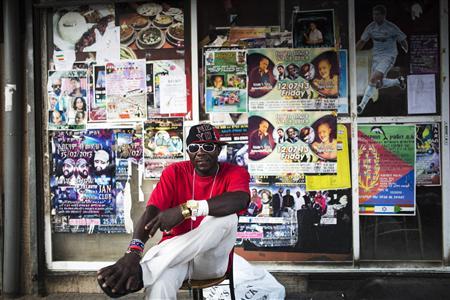 African migrant sits on a street corner in south Tel Aviv