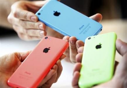 People check out several versions of the new iPhone 5C after Apple Inc's media event in Cupertino