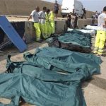 Body bags containing African migrants, who drowned trying to reach Italian shores, lie in the harbour of Lampedusa