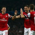 Arsenal's Ozil celebrates with teammates after scoring a goal against Napoli during their Champions League soccer match at the Emirates stadium in London