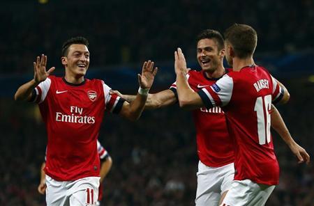 Arsenal's Ozil celebrates with teammates after scoring a goal against Napoli during their Champions League soccer match at the Emirates stadium in London