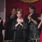 Comedian and actress Burnett is applauded by her husband and members of her private box as she arrives to be feted during the presentation of the Mark Twain Prize for American Humor in Washington