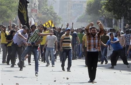 Clashes between supporters of Mohamed Mursi and anti Mursi protesters during march in Shubra street in cairo