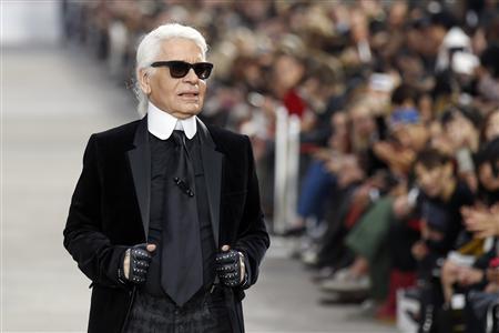 German designer Karl Lagerfeld appears at the end of his Spring/Summer 2014 women's ready-to-wear fashion show for French fashion house Chanel during Paris fashion week