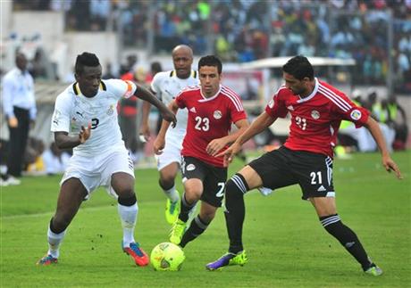 Ghana's Asamoah Gyan, left, battles with Egypt's Mohamed Naguib and Ahmed Shedid, right