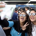 Children take pictures during an attempt to break a world record for largest gathering of people wearing googly eye glasses at a Halloween party in Los Angeles