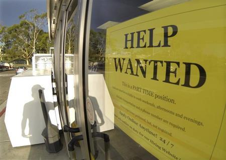 A help wanted sign is posted on the door of a gas station in Encinitas, California